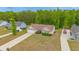 Aerial view of a home with well manicured lawn and driveway surrounded by large mature trees at 247 Rolling Oak Dr., Georgetown, SC 29440