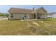 Exterior view of a home with a covered patio and a spacious backyard with green grass at 247 Rolling Oak Dr., Georgetown, SC 29440