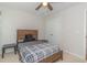Bedroom features a wooden bed frame with a black and grey comforter and ceiling fan at 247 Rolling Oak Dr., Georgetown, SC 29440