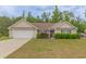 Charming single-story home features a two-car garage and well-maintained landscaping with mature shrubs at 247 Rolling Oak Dr., Georgetown, SC 29440