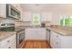 Bright kitchen features stainless steel appliances, white cabinets, and granite countertops at 247 Rolling Oak Dr., Georgetown, SC 29440