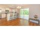 Bright kitchen and breakfast nook with white cabinets, bar seating, and access to patio at 247 Rolling Oak Dr., Georgetown, SC 29440