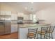 Modern kitchen with white cabinets, granite countertops, stainless appliances, and an eat-in bar at 247 Rolling Oak Dr., Georgetown, SC 29440