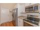 Kitchen features stainless steel appliances, granite countertops, and white cabinetry at 247 Rolling Oak Dr., Georgetown, SC 29440