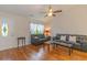 Cozy living room with hardwood floors, natural light, vaulted ceilings, and access to the dining area at 247 Rolling Oak Dr., Georgetown, SC 29440