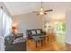 Spacious living room with hardwood floors, vaulted ceiling, ceiling fan, and large window at 247 Rolling Oak Dr., Georgetown, SC 29440