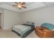 Bedroom featuring tray ceiling, ceiling fan, sitting area, and bedroom furniture at 247 Rolling Oak Dr., Georgetown, SC 29440