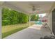 Covered patio with ceiling fan overlooking a large yard and outdoor seating at 247 Rolling Oak Dr., Georgetown, SC 29440