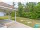 View of covered patio with pillars and a ceiling fan, overlooking a lush, green backyard at 247 Rolling Oak Dr., Georgetown, SC 29440