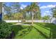 Spacious backyard with lush green grass, mature trees, a patio area, and a white picket fence at 2615 Painted Trillium Ct., Myrtle Beach, SC 29579