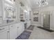 Luxurious bathroom with double vanities, elegant mirrors, modern lighting, and a glass-enclosed shower at 2615 Painted Trillium Ct., Myrtle Beach, SC 29579