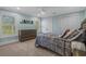 Bright bedroom with a blue accent wall, modern dresser, and large windows with shutters at 2615 Painted Trillium Ct., Myrtle Beach, SC 29579