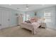 Charming bedroom with soft colors, plush bedding, and natural light from windows at 2615 Painted Trillium Ct., Myrtle Beach, SC 29579