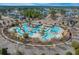 Aerial view of a large community pool area with multiple pools, sun decks, and lounge chairs at 2615 Painted Trillium Ct., Myrtle Beach, SC 29579