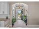 Open foyer with hardwood floors, leading to a bright living area with backyard views and a kitchen space at 2615 Painted Trillium Ct., Myrtle Beach, SC 29579