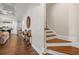 Inviting hallway with hardwood floors, elegant staircase, and decorative accents at 2615 Painted Trillium Ct., Myrtle Beach, SC 29579