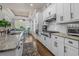 Bright, well-appointed kitchen features stainless appliances, white cabinetry, granite counters, and an open dining area at 2615 Painted Trillium Ct., Myrtle Beach, SC 29579