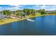 A serene lake view with a small dock and homes nestled among lush trees along the shoreline at 2615 Painted Trillium Ct., Myrtle Beach, SC 29579