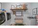 Well-organized laundry room with front load machines, storage, and decorative wall art at 2615 Painted Trillium Ct., Myrtle Beach, SC 29579