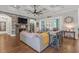 Spacious living room with a stone fireplace, beamed ceiling, hardwood floors and backyard view at 2615 Painted Trillium Ct., Myrtle Beach, SC 29579