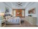 Tranquil main bedroom featuring wood accent wall, king bed, bench, and light blue walls at 2615 Painted Trillium Ct., Myrtle Beach, SC 29579