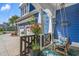 Cozy front porch featuring a hanging swing, flowers and view of the garage with blue siding at 2615 Painted Trillium Ct., Myrtle Beach, SC 29579