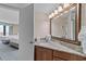 Bathroom featuring wood vanity with granite counter and a large mirror next to the bedroom at 2701 N Ocean Blvd. # 561/563, Myrtle Beach, SC 29577