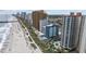 Gorgeous aerial view featuring sandy beach, ocean, palm trees, swimming pool, and several buildings at 2701 N Ocean Blvd. # 561/563, Myrtle Beach, SC 29577