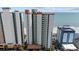 An exterior, high-angle view of a tall condominium building located near the beach and the ocean at 2701 N Ocean Blvd. # 561/563, Myrtle Beach, SC 29577