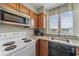 Well-equipped kitchen features wood cabinets, granite countertops, and a stainless steel microwave at 2701 N Ocean Blvd. # 561/563, Myrtle Beach, SC 29577