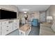 Bright living room with sleeper sofa, chair, entertainment center, and dining table at 2701 N Ocean Blvd. # 561/563, Myrtle Beach, SC 29577