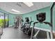 Well-equipped workout room with treadmills, elliptical, and weight machines and bright turquoise walls at 2701 N Ocean Blvd. # 561/563, Myrtle Beach, SC 29577