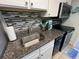 Modern kitchen featuring stylish backsplash, stainless steel sink and black electric stove at 2701 S Ocean Blvd. # 1507, North Myrtle Beach, SC 29582