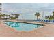 Outdoor pool featuring blue lounge chairs and many palm trees at 2701 S Ocean Blvd. # 1507, North Myrtle Beach, SC 29582