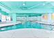 Indoor pool with white tile and lounge chairs in the surrounding area at 2701 S Ocean Blvd. # 1507, North Myrtle Beach, SC 29582