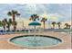 Outdoor pool with many palm trees and blue lounge chairs at 2701 S Ocean Blvd. # 1507, North Myrtle Beach, SC 29582