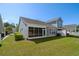 Expansive backyard showcasing lush lawn, screened porch, and privacy fencing at 320 Saint Catherine Bay Ct., Surfside Beach, SC 29575