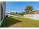 Well-maintained backyard with green grass, white picket fence, and view of neighborhood homes at 320 Saint Catherine Bay Ct., Surfside Beach, SC 29575