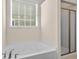 Well-lit bathroom featuring a bathtub and a shower with a modern glass door at 320 Saint Catherine Bay Ct., Surfside Beach, SC 29575