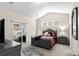Comfortable bedroom with sliding glass doors to outdoor seating area and abundant natural light at 320 Saint Catherine Bay Ct., Surfside Beach, SC 29575