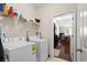 Bright laundry room with washer, dryer, and shelving for organized storage solutions at 320 Saint Catherine Bay Ct., Surfside Beach, SC 29575