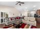 Open living room with a ceiling fan, vaulted ceilings, and a sliding glass door to patio at 320 Saint Catherine Bay Ct., Surfside Beach, SC 29575