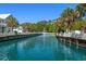 Community pond with fountain surrounded by well-manicured lawns and white picket fences at 320 Saint Catherine Bay Ct., Surfside Beach, SC 29575