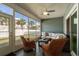 Cozy sunroom with wicker furniture, ceiling fan, and view of fenced backyard at 320 Saint Catherine Bay Ct., Surfside Beach, SC 29575