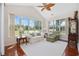 Inviting sunroom with large windows, hardwood floors, vaulted ceiling and comfortable seating at 3224 Hermitage Dr., Little River, SC 29566