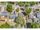 Aerial view of a home with a pool, shed, mature trees, and a long driveway in a neighborhood at 333 14Th Ave. S, Surfside Beach, SC 29575