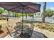 Outdoor patio with seating under a large umbrella, ideal for relaxation and gatherings at 333 14Th Ave. S, Surfside Beach, SC 29575