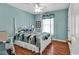 Comfortable bedroom with light blue walls, a four-poster bed and hardwood floors at 333 14Th Ave. S, Surfside Beach, SC 29575