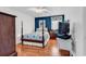Comfortable bedroom with dark blue walls, a four-poster bed and hardwood floors at 333 14Th Ave. S, Surfside Beach, SC 29575
