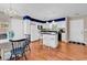 Modern kitchen with white cabinets, a center island with stools, and a breakfast nook at 333 14Th Ave. S, Surfside Beach, SC 29575